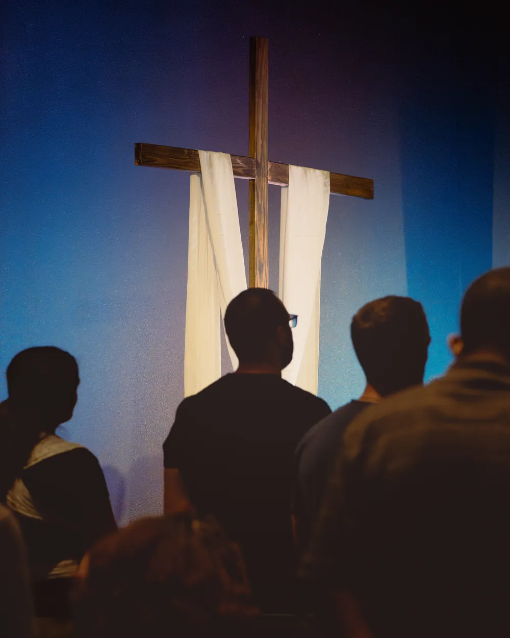People worshiping in front of the cross at a Breakthrough Church Saturday gathering
